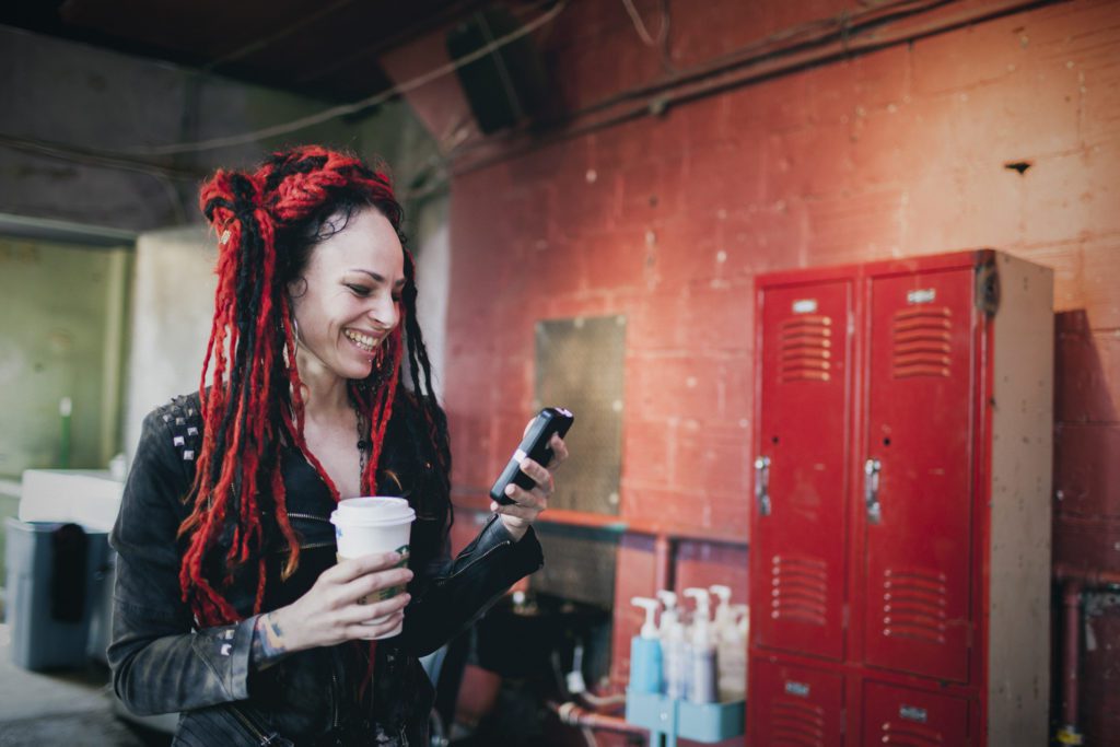 Branding 1. coffee up, iphone, woman with red braids, lockers, brick wall
